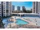 View of the pool, sundeck, and outdoor lounging area at 1 Oceans West Blvd # 3B4, Daytona Beach, FL 32118