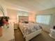 Comfortable bedroom with a queen-sized bed, warm lighting, bright windows and charming floral accents at 114 Caladium St, Leesburg, FL 34748
