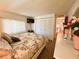 Bedroom featuring a comfortable bed, bright window, TV, closet, and access to other rooms at 114 Caladium St, Leesburg, FL 34748
