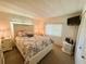 Cozy bedroom featuring a queen bed, neutral color palette, bright windows and a convenient TV at 114 Caladium St, Leesburg, FL 34748