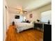 Relaxing bedroom with hardwood floors, TV and an abundance of natural light at 114 Caladium St, Leesburg, FL 34748