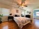 Comfortable bedroom with stylish decor, ceiling fan and hardwood floors at 114 Caladium St, Leesburg, FL 34748