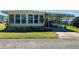 Charming mobile home with large windows and attached carport in a well-maintained community at 114 Caladium St, Leesburg, FL 34748