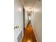 Hallway with wood flooring leading to other rooms in the home at 114 Caladium St, Leesburg, FL 34748