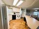 Open concept kitchen, featuring white appliances with a view of the dining area at 114 Caladium St, Leesburg, FL 34748