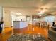 Open-concept kitchen and dining area with white cabinets and modern appliances, great for entertaining at 114 Caladium St, Leesburg, FL 34748