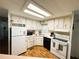 Bright kitchen equipped with white cabinets, laminate countertops, and an oven range at 114 Caladium St, Leesburg, FL 34748