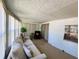 Relaxing sunroom with a cozy sofa, chair, and plenty of natural light at 114 Caladium St, Leesburg, FL 34748