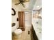 Bathroom with a tub, floral wallpaper, and brown accents, including a ceiling fan and shower curtain at 123 Pyracantha Ln, Leesburg, FL 34748