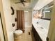 Bathroom with shower/tub combo, vinyl flooring, and dark wood vanity at 123 Pyracantha Ln, Leesburg, FL 34748