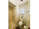 Bathroom featuring a shower stall, toilet, and window with decorative art at 123 Pyracantha Ln, Leesburg, FL 34748