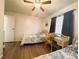 Comfortable bedroom with twin beds, ceiling fan and window at 123 Pyracantha Ln, Leesburg, FL 34748