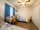 Bedroom featuring two twin beds, desk and ceiling fan at 123 Pyracantha Ln, Leesburg, FL 34748