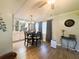 Well-lit dining room with modern light fixture, wood floors, display cabinet, and neutral paint at 123 Pyracantha Ln, Leesburg, FL 34748