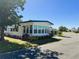 Inviting single-story home with lush green lawn, mature landscaping, and a welcoming neighborhood street at 123 Pyracantha Ln, Leesburg, FL 34748