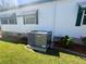 Exterior view of the home with an air conditioning unit and well-maintained landscaping at 123 Pyracantha Ln, Leesburg, FL 34748