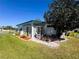 Charming home exterior with a sunroom, well-maintained lawn, and lush landscaping at 123 Pyracantha Ln, Leesburg, FL 34748