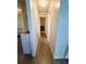 Hallway with vinyl flooring leads to bedrooms and bathroom at 123 Pyracantha Ln, Leesburg, FL 34748