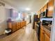 Spacious kitchen with stainless appliances, wood cabinets and wood-look vinyl flooring at 123 Pyracantha Ln, Leesburg, FL 34748
