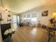 Open living room with plenty of natural light, wood floors, and comfortable seating at 123 Pyracantha Ln, Leesburg, FL 34748