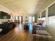 Comfortable living room features wood floors, a dining table, and a large entertainment center at 123 Pyracantha Ln, Leesburg, FL 34748