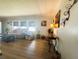 Bright living room with wood floors, neutral walls, and comfortable seating bathed in natural light at 123 Pyracantha Ln, Leesburg, FL 34748