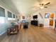 Cozy living room with wood floors, comfortable seating, a ceiling fan and ample natural light at 123 Pyracantha Ln, Leesburg, FL 34748