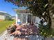 Outdoor patio space adjacent to the sunroom, with comfortable seating and decorative plants at 123 Pyracantha Ln, Leesburg, FL 34748