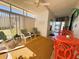 Well-lit sunroom with tile flooring, casual seating, and a welcoming atmosphere at 123 Pyracantha Ln, Leesburg, FL 34748