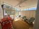 Bright sunroom with comfortable seating, a ceiling fan, and views of the outdoors at 123 Pyracantha Ln, Leesburg, FL 34748