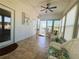 Cozy sunroom with tiled floors, ceiling fan, comfortable wicker furniture and access to the outdoors at 123 Pyracantha Ln, Leesburg, FL 34748