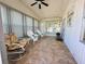 Relaxing sunroom with tiled floors, wicker furniture, and plenty of natural light at 123 Pyracantha Ln, Leesburg, FL 34748