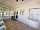 Serene sunroom with tiled floor, ceiling fan, natural light and outdoor views at 123 Pyracantha Ln, Leesburg, FL 34748