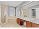 Bright bathroom featuring double sinks, walk-in shower, soaking tub, and tiled floors at 1333 Darnaby Way, Orlando, FL 32824