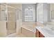 Bright bathroom featuring soaking tub and walk-in shower, and tile surround at 1333 Darnaby Way, Orlando, FL 32824