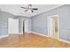 Spacious bedroom featuring hardwood floors, ceiling fan, and neutral color palette at 1333 Darnaby Way, Orlando, FL 32824
