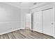 Bedroom featuring hardwood floors, neutral color palette, and closet space at 1333 Darnaby Way, Orlando, FL 32824