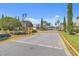 Gated community entrance with well-manicured landscaping and elegant street lamps at 1333 Darnaby Way, Orlando, FL 32824