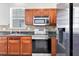 Close-up of the kitchen area with stainless steel appliances and dark wood cabinets at 1333 Darnaby Way, Orlando, FL 32824