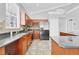 Well-equipped kitchen with dark cabinets, an island, stainless appliances, and tiled backsplash at 1333 Darnaby Way, Orlando, FL 32824