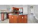 Open kitchen with stainless steel appliances, an island, and tile flooring at 1333 Darnaby Way, Orlando, FL 32824