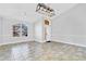 Bright living room featuring tile floors, arched window, and modern light fixture at 1333 Darnaby Way, Orlando, FL 32824