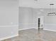 Spacious living area with decorative chair railing, tile flooring, and modern light fixture at 1333 Darnaby Way, Orlando, FL 32824