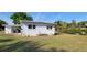 View of the home's backyard featuring the exterior, grass and an outside storage area at 1540 Avenue C Ne, Winter Haven, FL 33881