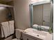 Well-lit bathroom with a shower, toilet, updated vanity, and mirror at 1640 Juno Trl # 101A, Astor, FL 32102