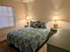 Cozy bedroom featuring a comfortable bed, two side tables with lamps and a window at 1640 Juno Trl # 101A, Astor, FL 32102