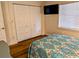 Bedroom with closet, TV, window, and color-coordinated decor at 1640 Juno Trl # 101A, Astor, FL 32102