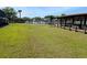 Expansive green lawn area by the lake, providing a serene and picturesque waterfront view at 1640 Juno Trl # 101A, Astor, FL 32102