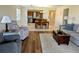 Comfortable living room and kitchen with plush seating, stylish decor, and tile and wood flooring at 1640 Juno Trl # 101A, Astor, FL 32102