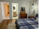 Comfortable bedroom with ensuite bathroom featuring a bed and dresser at 1640 Juno Trl # 101A, Astor, FL 32102